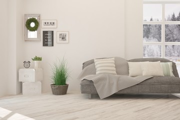 Stylish room in white color with sofa and winter landscape in window. Scandinavian interior design. 3D illustration