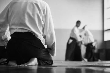 Foto op Plexiglas Aikido training. Black and white image. The teacher shows reception.  Traditional form of clothing in Aikido. © Uladzimir