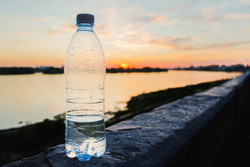 plastic bottle on the background of the sunset, the background for designers