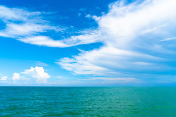 Ocean wave on tropical beach with golden sand and ripple of water splash from emerald blue-green sea water during summer vacation. 