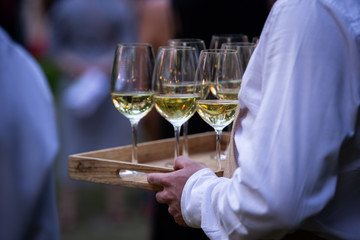 white wine glasses on a tray