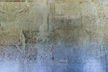 Famous bas reflief carved in the wall of Angkor Wat temple, world heritage and most visited tourist site, Cambodia. Details, close up of epic battles rock carving.