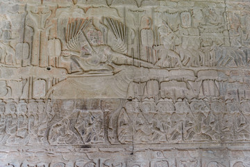 Famous bas reflief carved in the wall of Angkor Wat temple, world heritage and most visited tourist site, Cambodia. Details, close up of epic battles rock carving.