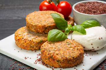 Tasty vegetarian burgers made from healthy quinoa, basil, tomatoes and mozzarella cheese