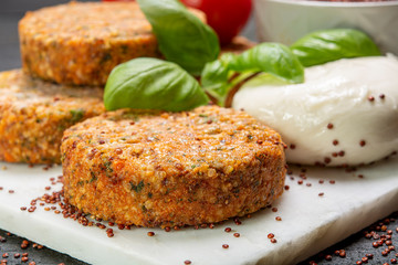 Tasty vegetarian burgers made from healthy quinoa, basil, tomatoes and mozzarella cheese