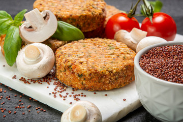 Tasty vegetarian and vegan burgers made from healthy quinoa, basil, tomatoes and champignon mushrooms