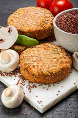 Tasty vegetarian and vegan burgers made from healthy quinoa, basil, tomatoes and champignon mushrooms