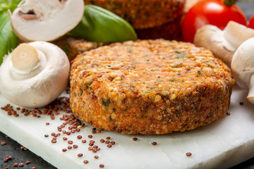 Tasty vegetarian and vegan burgers made from healthy quinoa, basil, tomatoes and champignon mushrooms