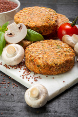 Tasty vegetarian and vegan burgers made from healthy quinoa, basil, tomatoes and champignon mushrooms
