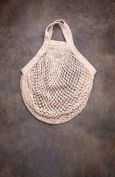 Natural string bag tote handle on dark background, top view