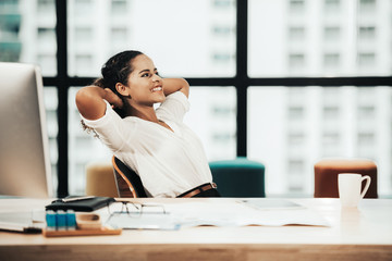 Relax time.  Successful Businesswoman relaxing  and resting after sitting and hard working in modern office. Healthy care for time. Business Concept