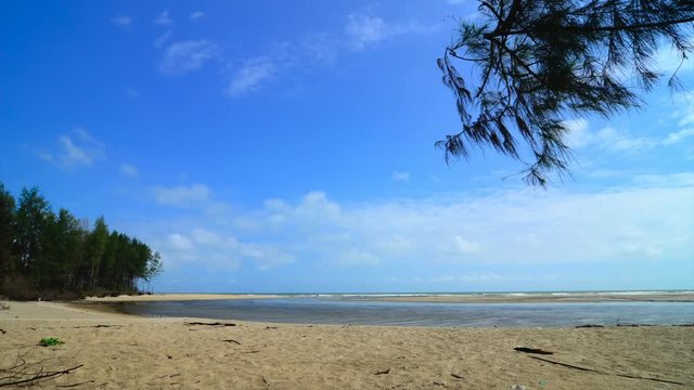 footage of tropical seascape under bright sunny day and blue sky background. wave hitting the shoreline