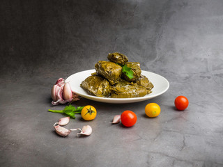 Dolma tolma, sarma - stuffed grape leaves with rice and meat. Traditional Caucasian, Ottoman, Turkish and Greek cuisine