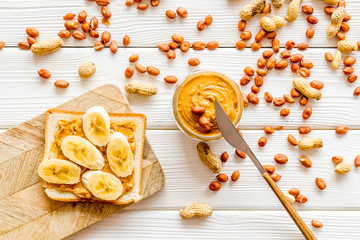 peanut butter for cooking breakfast with sandwiches at home on white wooden background top view pattern