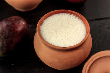 Fresh lassi in traditional indian clay pot.