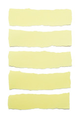 Collection of yellow paper stripes with torn edges isolated on white background