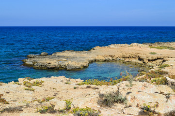 Protaras, the island of Cyprus. Mediterranean coastline. A serene day, blue sky, coral coast. Background. Copy space.