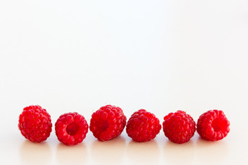 A group of bright, juicy berries of the garden raspberry on a white background. Isolated. Close-up. © Olga