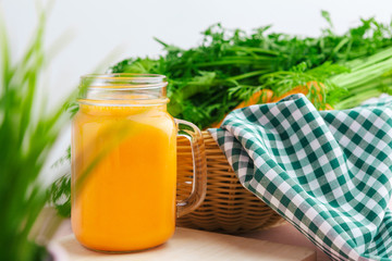 Carrot smoothie with parsley on a table