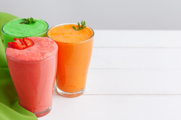 Row of healthy fresh fruit and vegetable smoothies