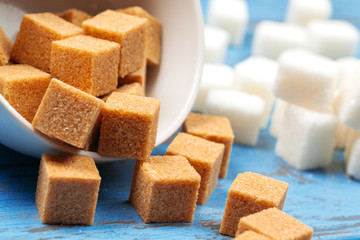 White refined sugar and brown unrefined sugar cubes