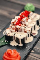 Healthy food. Japanese restaurant. Sushi roll on a black background