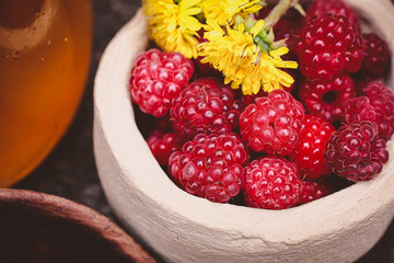 raspberry and honey in a beautiful dish on a wooden table