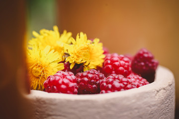 raspberry and honey in a beautiful dish on a wooden table