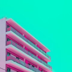 Pink hotel and green sky in infrared style. Tropical travel concept. Minimalism