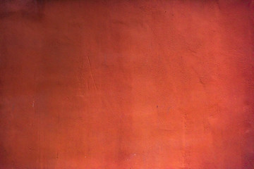 Dark grunge concrete wall texture painted in red color