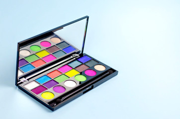 Neon palette of shadows on a blue background.