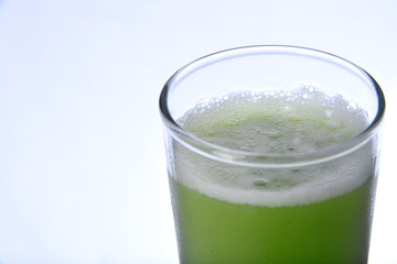 green juice with natural fruits on white background