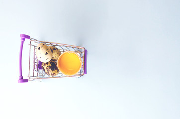 Small shopping car with quail and chicken eggs.