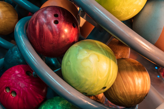 multicolored bowling balls in stack
