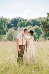 Tender couple kissing in the meadow