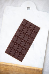 Dark chocolate on marble background with copy space