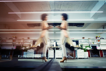 Fototapeta na wymiar Professional business woman in motion with blur in business office