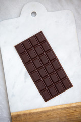 Dark chocolate on marble background with copy space