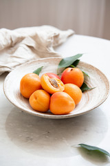Wicker basket apricot on a marble background with copy space and daylight