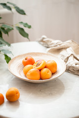 Wicker basket apricot on a marble background with copy space and daylight