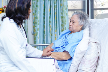 Fototapeta premium Doctor care, help and support senior or elderly old lady woman patient at hospital ward : healthy strong medical concept.