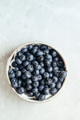 Blueberry bowl on white background with copy space in rustic style