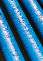 Many old blue pipes. Pipeline used in different industry ways: gas, water or vapor supply. Close up