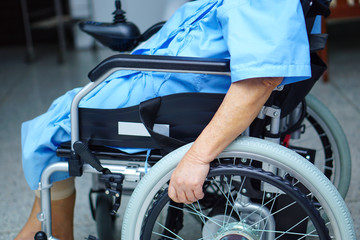 Obraz premium Asian senior or elderly old lady woman patient on electric wheelchair with remote control at nursing hospital ward : healthy strong medical concept 