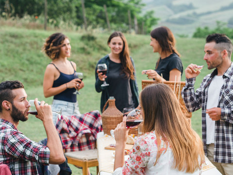 Group Of Friends During A Barbecue In The Countryside - Millennials Drinking Red Wine