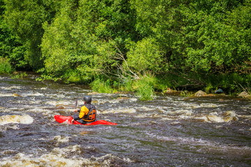 Man rafting on the forest river