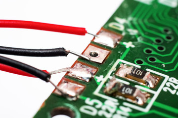 Green PCB with transistors and tracks closeup