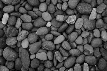 pebbles on the beach , black stone background