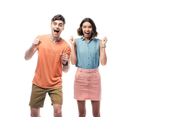 Obraz premium excited man and woman smiling at camera and showing yes gestures isolated on white
