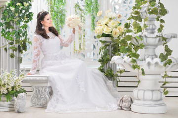 Fototapeta premium Portrait of young beautiful bride in white dress posing